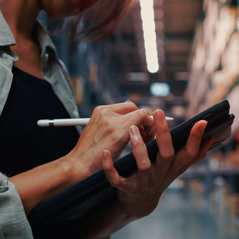 A woman writing on a tablet 