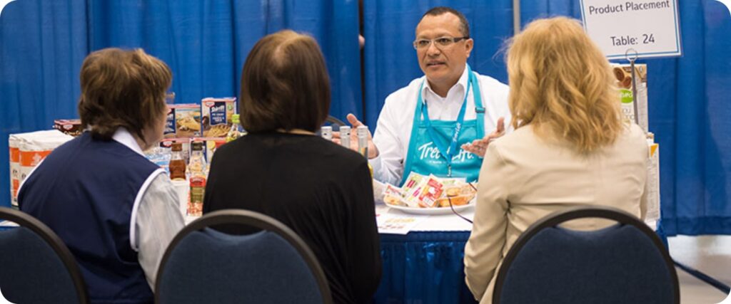 A Tree of Life rep presenting at a tradeshow
