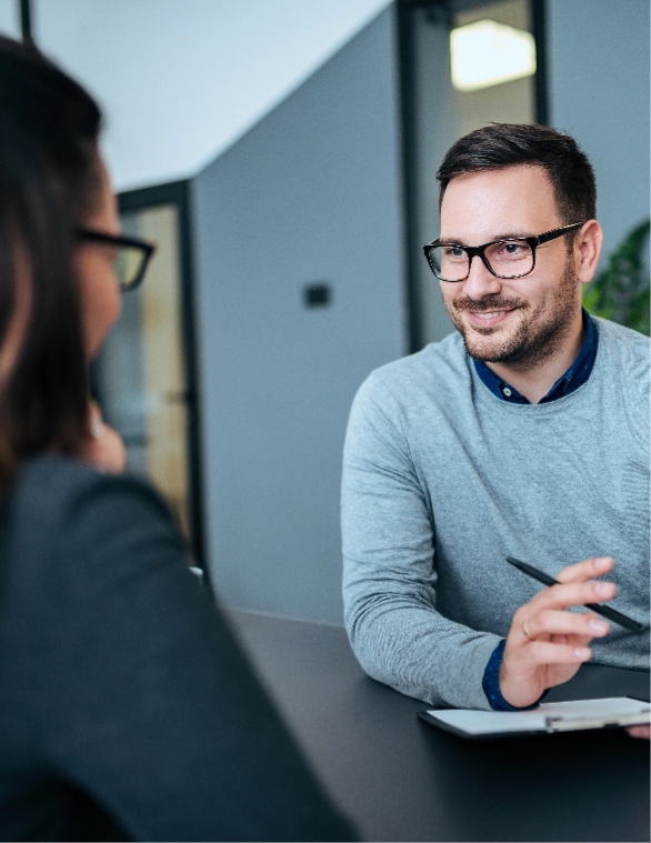 A man wearing glasses at a job interview