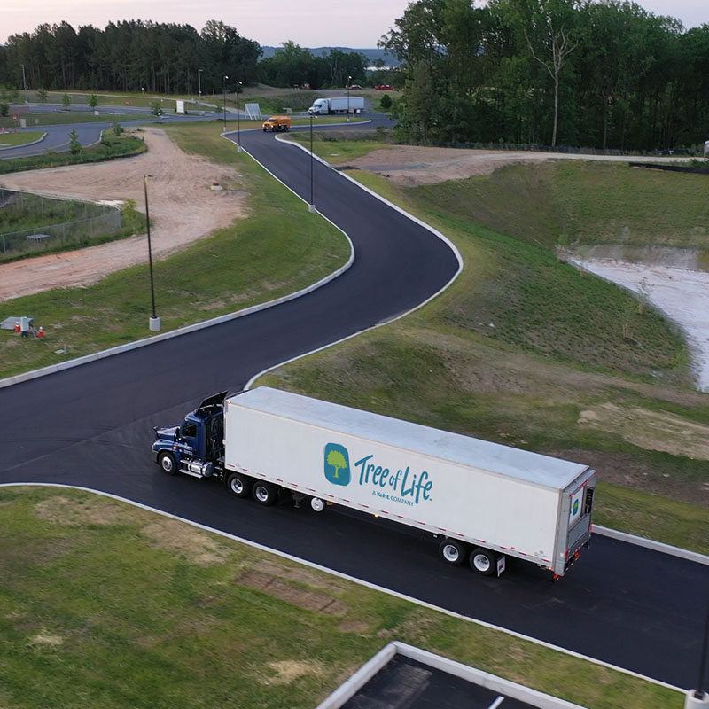 A transport truck with the Tree of Life logo on the side