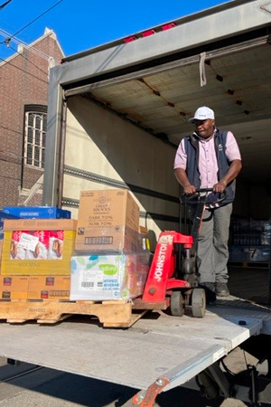 A delivery man unloading products from a truck